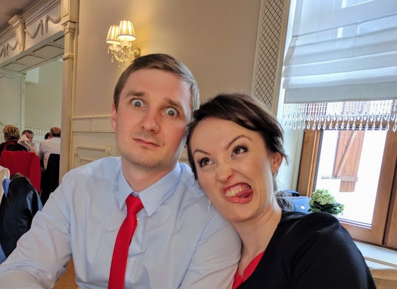 Young couple making funny face at a Polish wedding